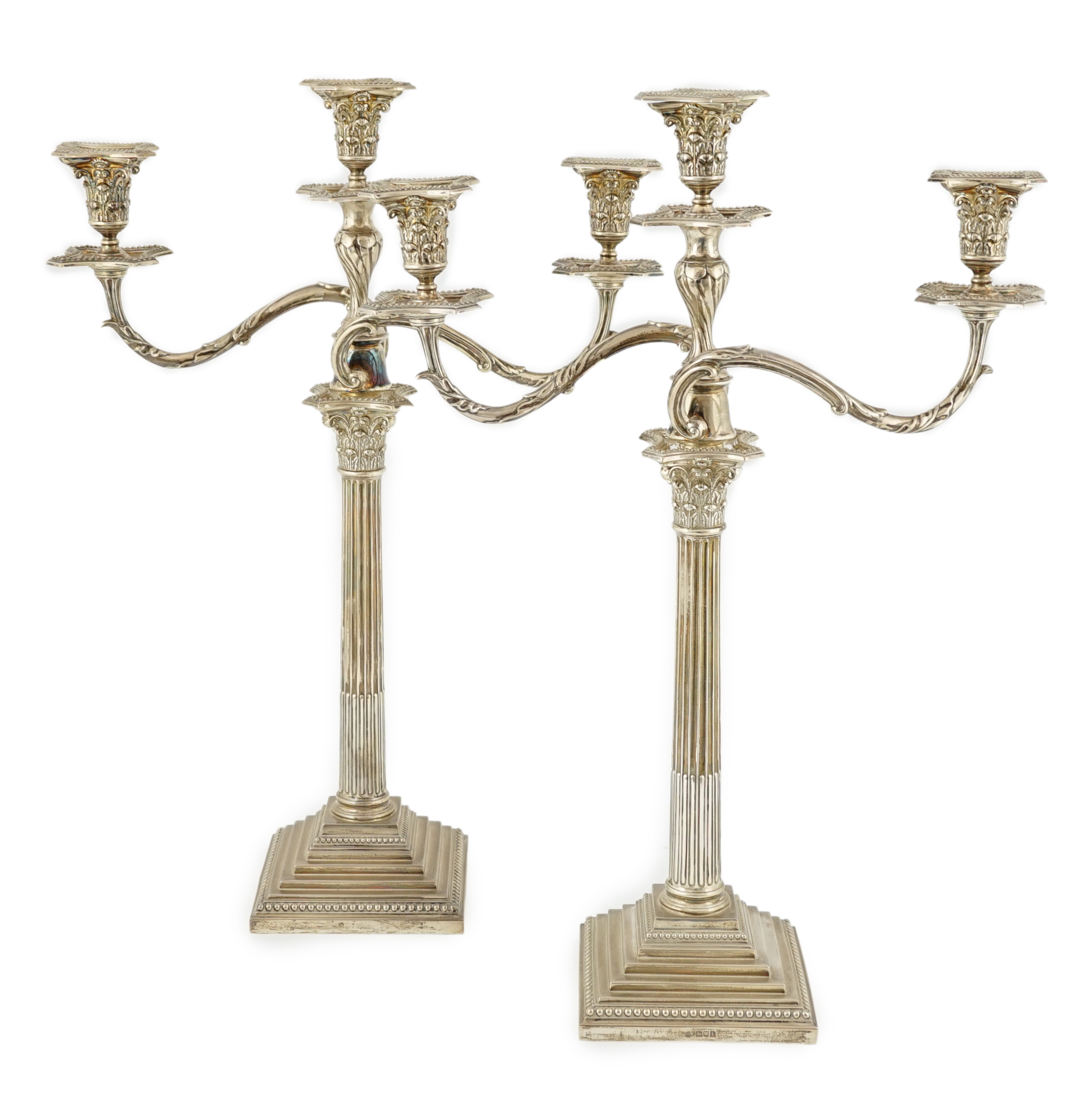 A pair of Edwardian silver two branch, three light Corinthian column candelabra, by William Hutton & Sons